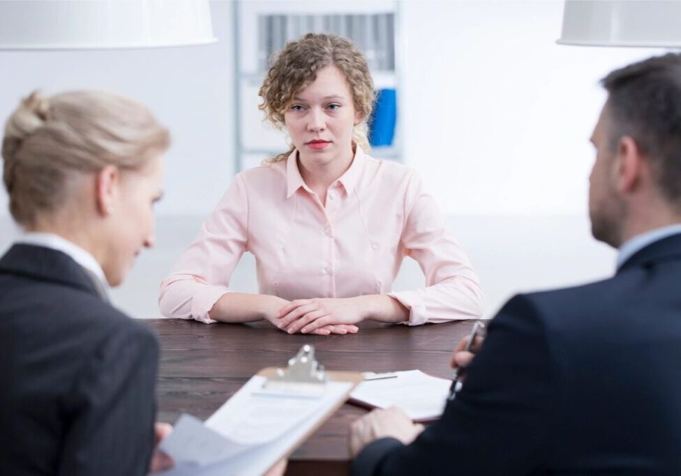 Job interview with three people at table.