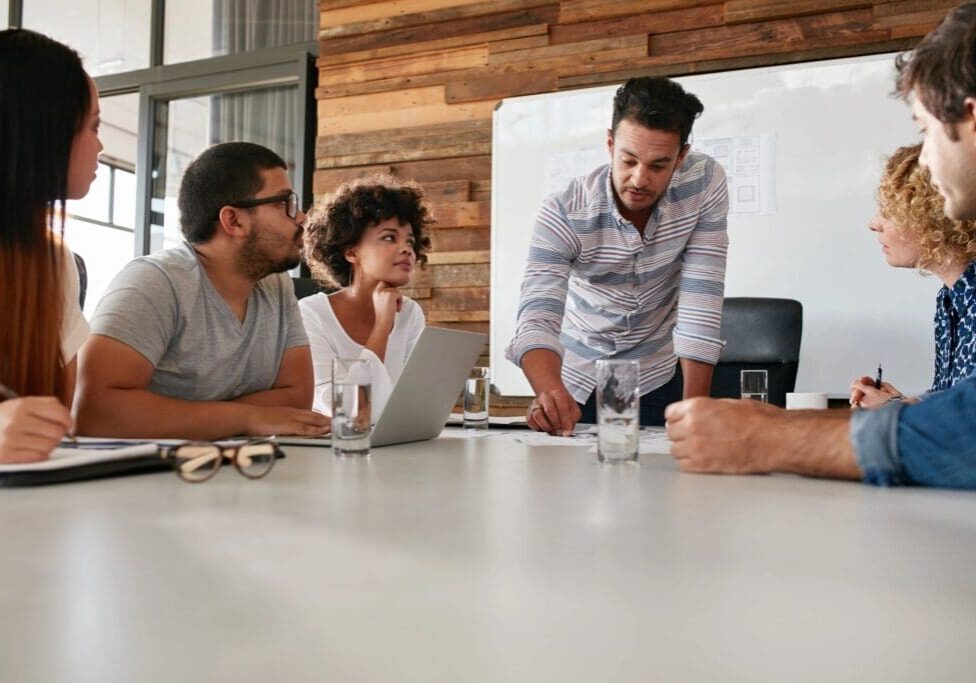 Colleagues collaborating around conference table