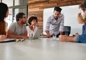 Colleagues collaborating around conference table