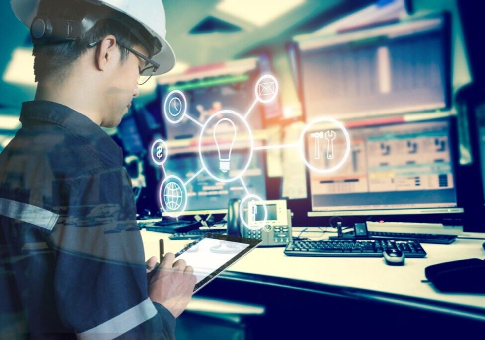 Engineer analyzing data on multiple screens.