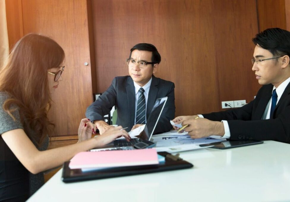 Three professionals having a business meeting.